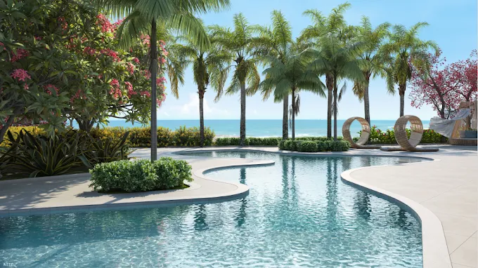 Área de lazer do Manami Ocean Living Guarapari com piscina orgânica, palmeiras e vista panorâmica para o mar da Enseada Azul.