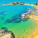 Previsão do Tempo em Guarapari para domingo 5 de abril de 2026 com céu nublado, pancadas rápidas de chuva e máxima de 29°C
